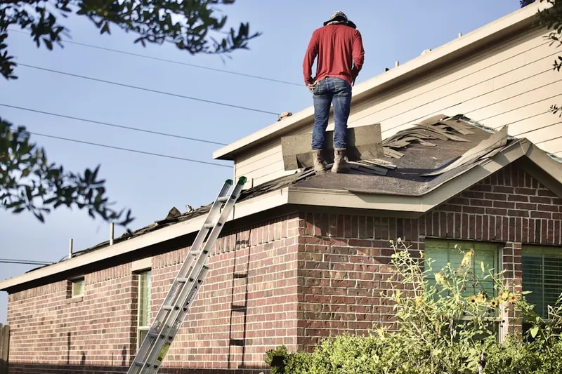 Professional roofer working on a residential roof in East Peoria